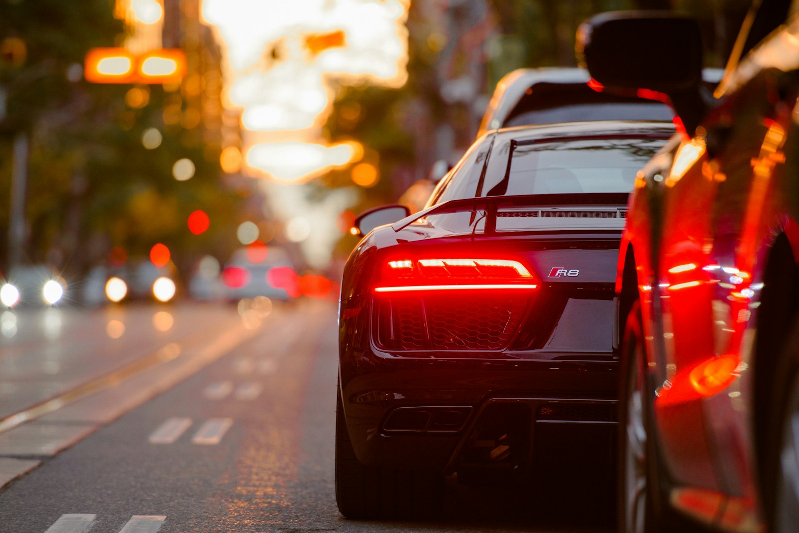 Rear of an Audi in city traffic at sunset