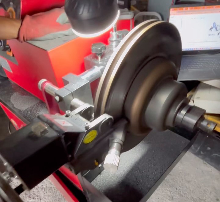 A brake disc being machined on the workshop lathe