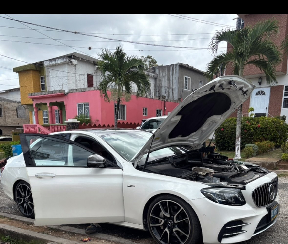 A Mercedes-AMG E53 with the bonnet up outside JRC Automotive in Ocho Rios