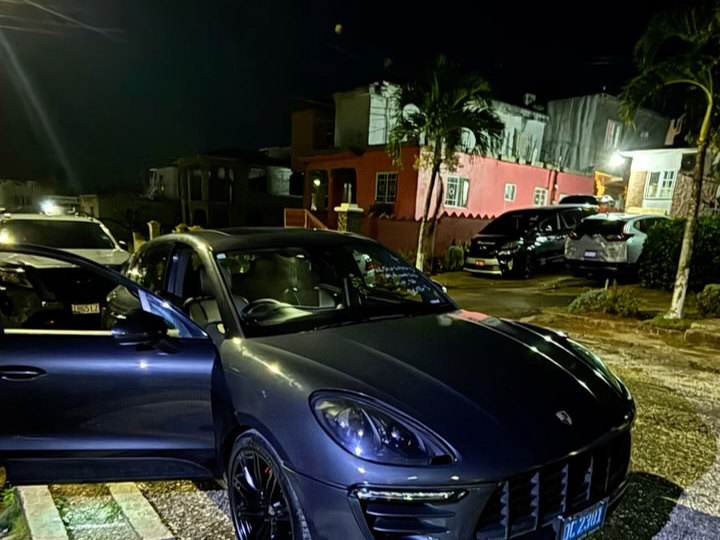 A Porsche Macan at JRC Automotive at night