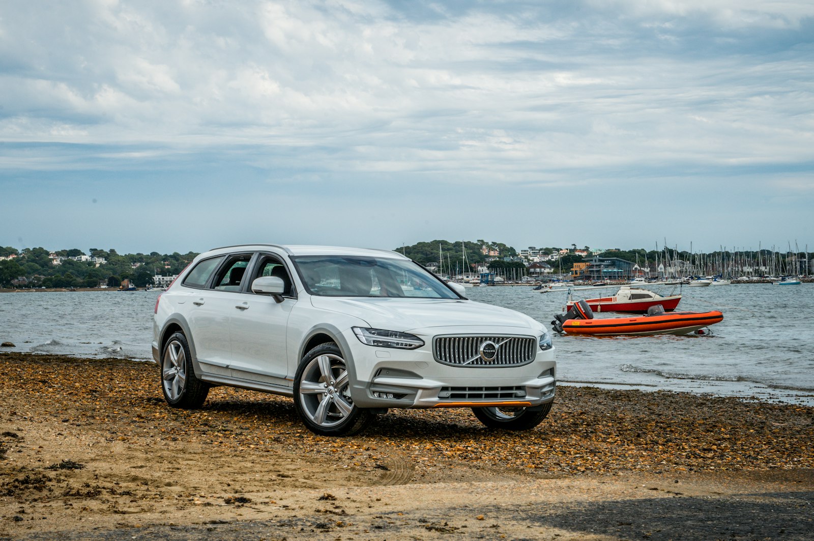 A white Volvo estate parked by the sea